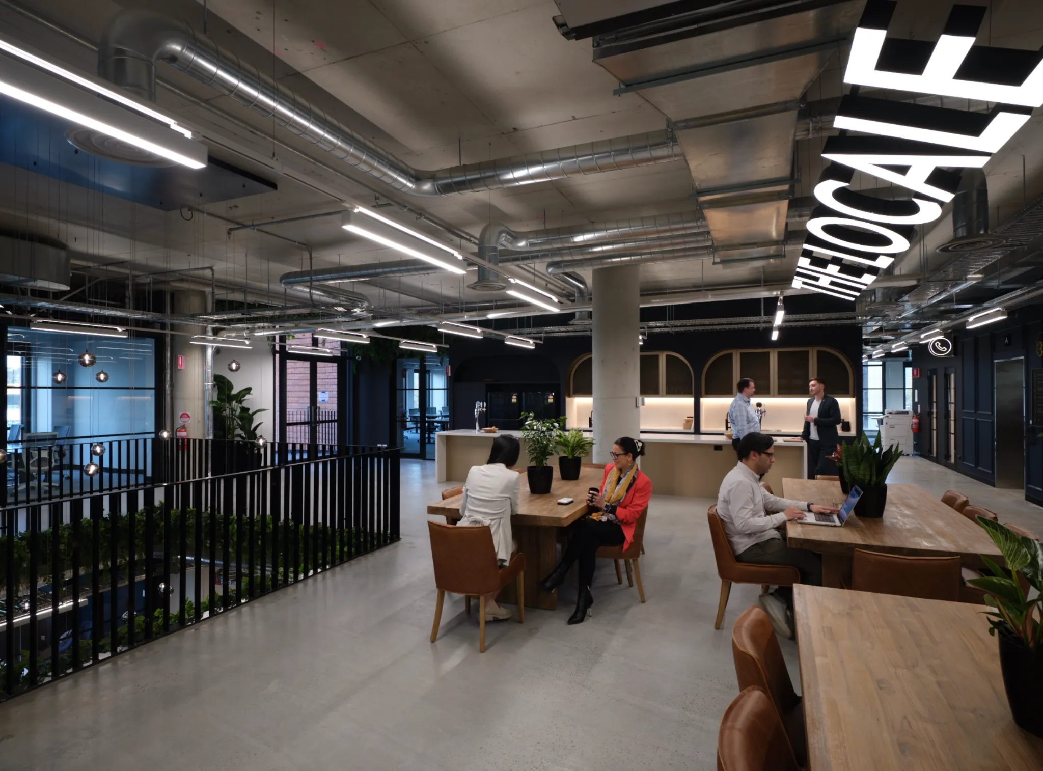 Open coworking space with lounge seating and cafe-style tables at CorporateCubes.Co Sydney