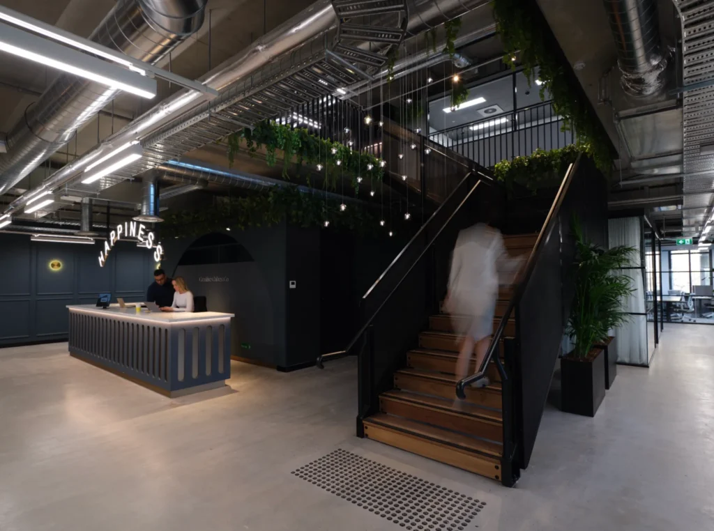 CorporateCubes.Co coworking reception and staircase showcasing modern workspace design and growth strategy