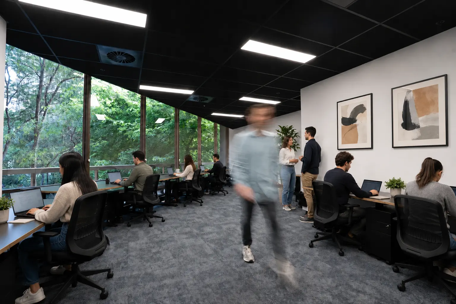 Small Australian team working together inside a modern flexible private office with shared coworking amenities